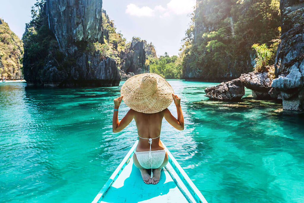 Group of friends enjoying a beach day under the sun, representing the best summer activities for 2025."